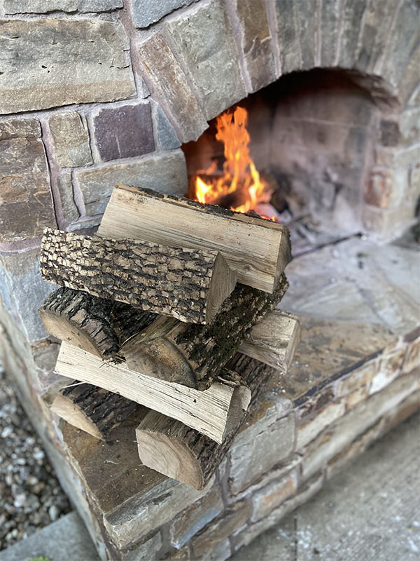 Firewood stacked by a fireplace