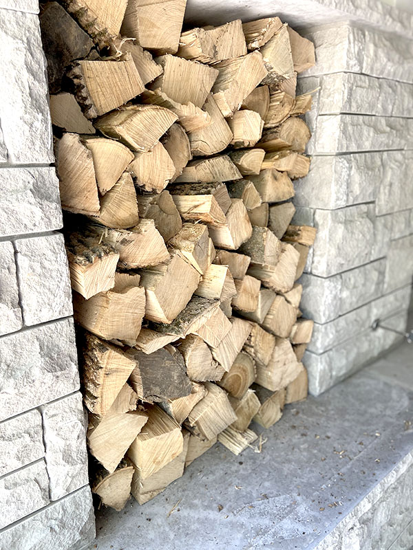 Peach wood stacked in a rocky hole in the wall